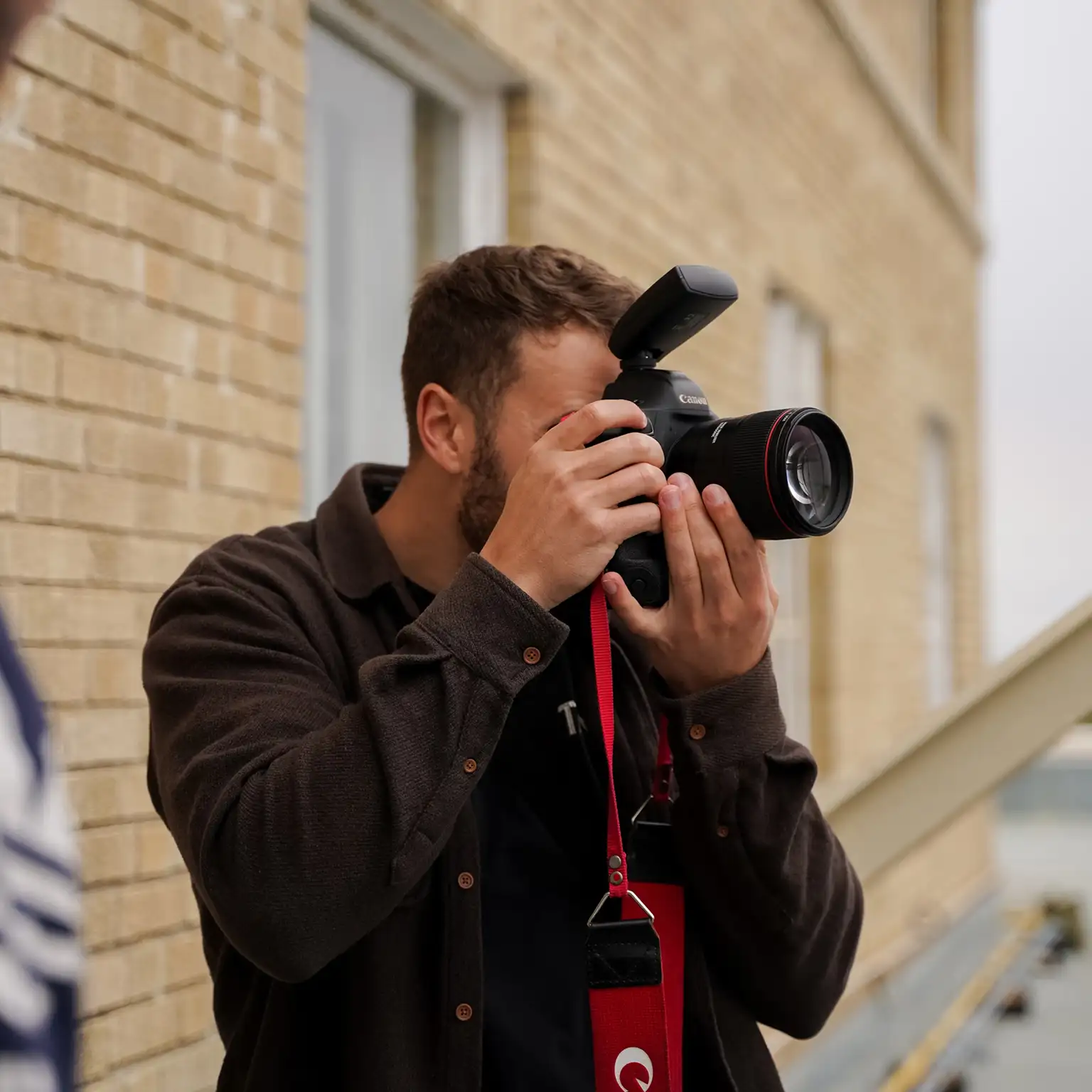 A photographer capturing moments with a camera in a natural setting.